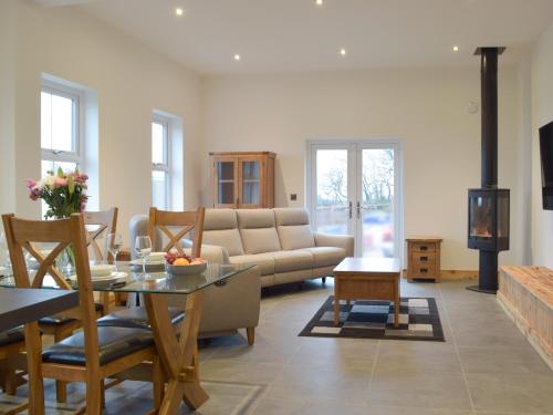 a living room with a couch and a table at Stambar in Llanglydwen