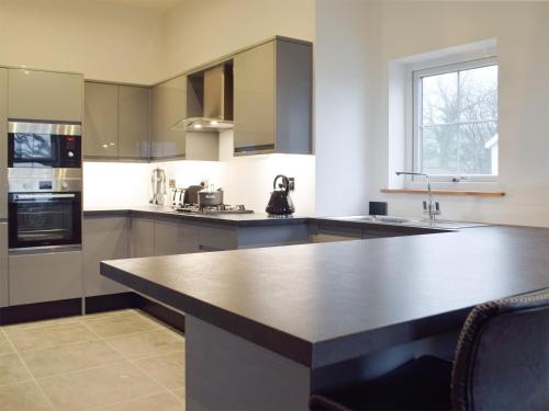 a kitchen with a large island in the middle at Stambar in Llanglydwen