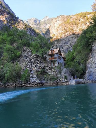 a house sitting on the side of a river at Te Konaku, Komani Lake in Kajvall