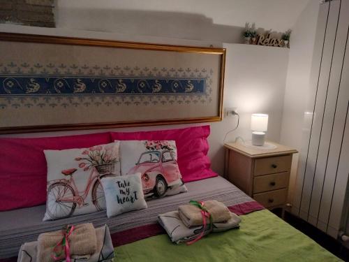 a bedroom with a bed with a car and pillows at Apartments Aurora Delle Rose in Assisi