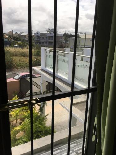 a view from a window of a building at Spacious Apartment in Mahébourg with Sea View in Mahébourg