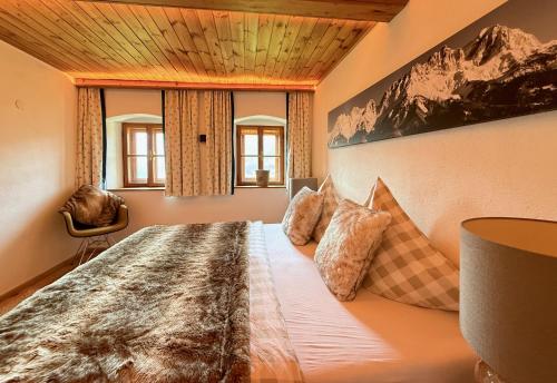 a bedroom with a large bed in a room at DER ERLACHER Alpenrefugium 1874 LUXERY & PRIVACY by Belle-Stay in Jochberg