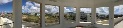 a view of a city from a window in a building at Spacious Apartment in Mahébourg with Sea View in Mahébourg