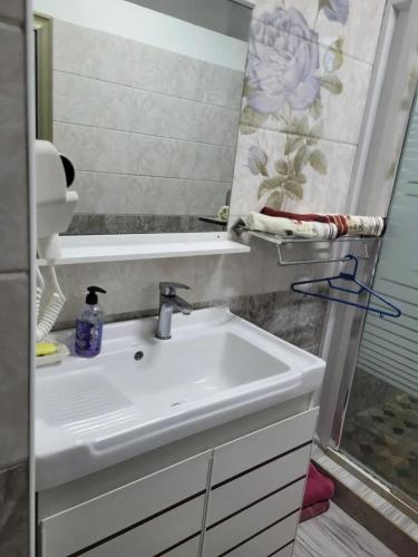 a bathroom with a sink and a mirror at Spacious Apartment in Mahébourg with Sea View in Mahébourg
