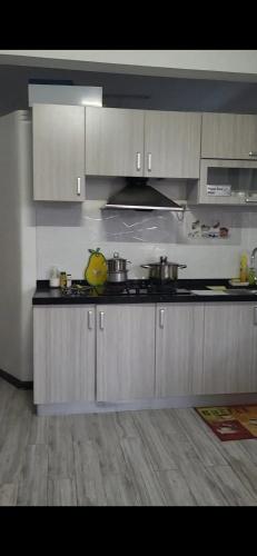 a kitchen with white cabinets and a counter top at Spacious Apartment in Mahébourg with Sea View in Mahébourg
