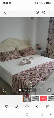 a picture of a bed with two pillows on it at Spacious Apartment in Mahébourg with Sea View in Mahébourg