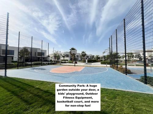 a basketball court with a sign in the grass at Yas Island Villa 4br Smart Luxury-near Yas Parks in Abu Dhabi