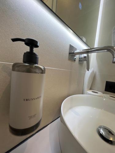 a soap dispenser sitting on top of a bathroom sink at Mina Luxury Rooms in Tirana