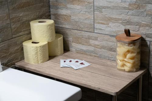 a table with three rolls of toilet paper and a jar at Haus Kärnten in Döbriach