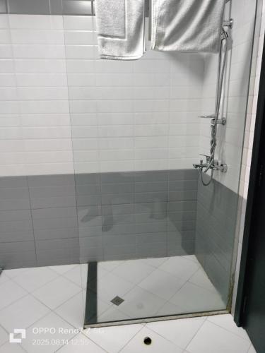a shower with a glass door in a bathroom at City Point Hotel in Manama