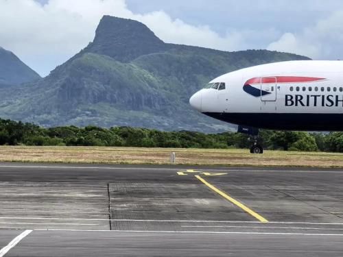 an airplane is sitting on the runway at an airport at Spacious Apartment in Mahébourg with Sea View in Mahébourg