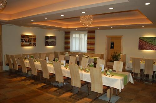 a conference room with a long table and chairs at Gasthof Huber in Wels