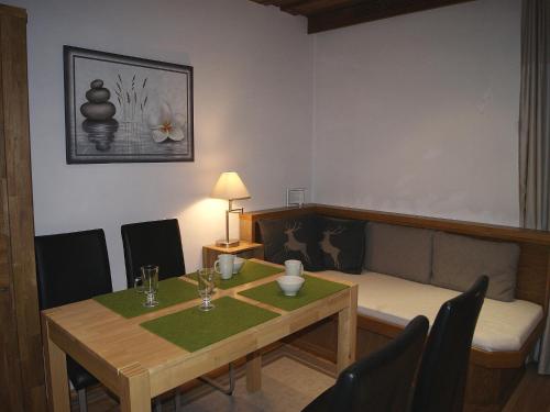 a dining room with a table and a couch at Apartment am Wolfgangsee in Strobl