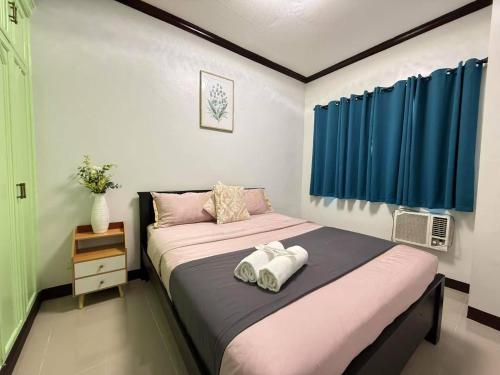 a bedroom with a bed with two towels on it at Touristation @ Crowne Bay Tower in Manila