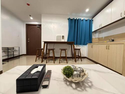 a kitchen with a table and a bowl of vegetables at Touristation @ Crowne Bay Tower in Manila