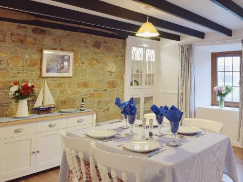 a dining room with a table with blue bows at Ty Capel Seion in Cardigan
