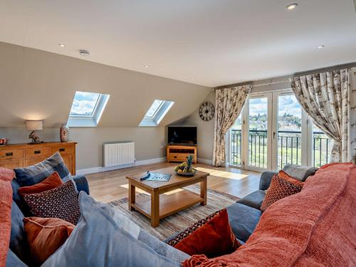 a living room with a couch and a table at 2 Bed in Auchterarder 94546 in Auchterarder
