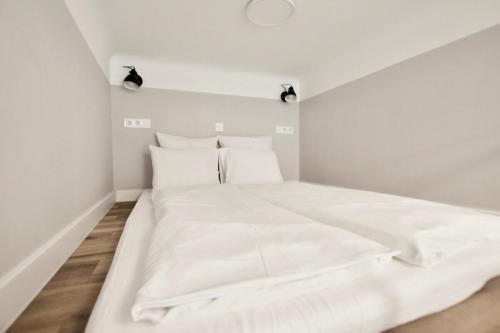 a bedroom with a large white bed with two pillows at Standard Apartment by Hi5- Fehérhajó Studio in Budapest