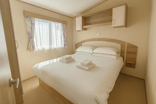 a bedroom with a bed with two towels on it at Lower Cliff 10 in Portland