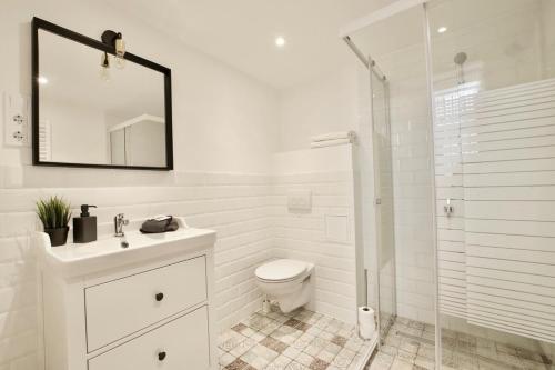 a white bathroom with a toilet and a shower at Standard Apartment by Hi5- Fehérhajó Studio in Budapest