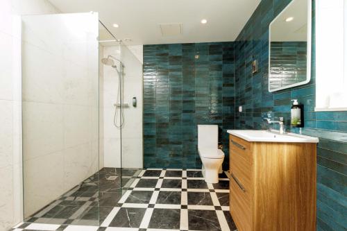 a bathroom with a toilet and a glass shower at Club House Hotel Kilkenny in Kilkenny
