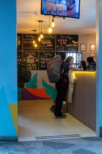 a person standing at a bar in a restaurant at Wild Rover Huacachina in Ica