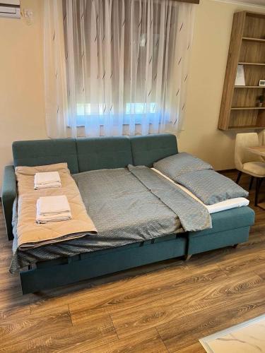 a bed with two pillows on it in a room at Casa Due in Novi Sad
