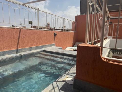 a swimming pool on the side of a building at Riad Dihya in Marrakech