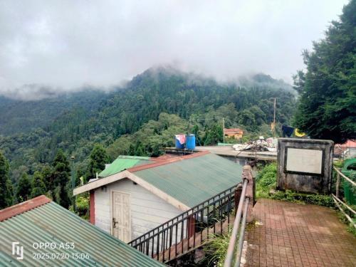 a view of a mountain with clouds in the sky at The Himalayan Horizon Homestay Lava in Lava
