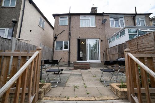 a patio with chairs in front of a house at 3 Bed Pet Friendly Home, With BBQ in Dartford