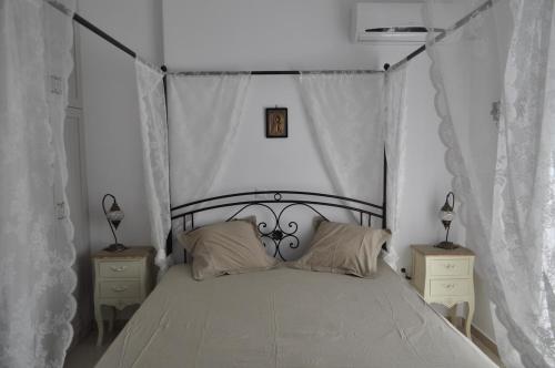 a bedroom with a large bed with two night stands at Fairytale View in Karistos