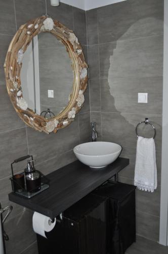 a bathroom with a sink and a mirror at Fairytale View in Karistos
