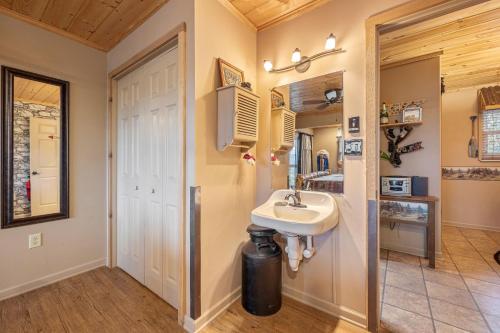 a bathroom with a sink next to a door at Dolly Bear by American Patriot Getaways in Shady Grove