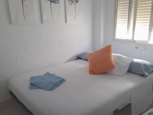 a white bed with pillows on it in a room at A Beautiful Townhouse in Rute