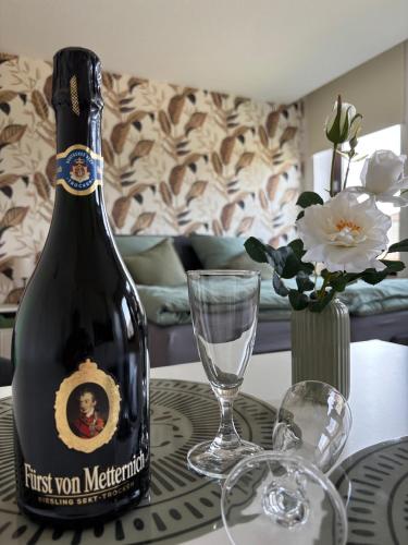 a bottle of wine sitting on a table with a glass at Ferienwohnung, Apartment Schwertherz in Wulfsen