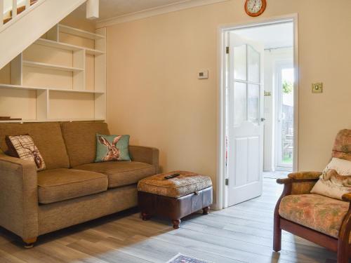 a living room with a couch and a chair at Woodlander in Dorchester
