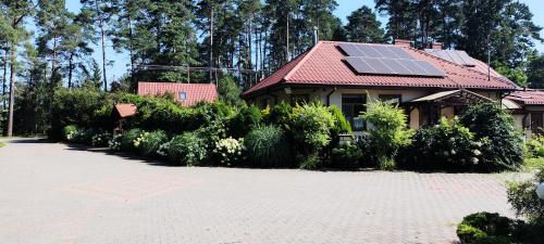 a house with a roof with solar panels on it at Agroturystyka,Noclegi,Pokoje Gościnne,Usługi Agroturystyczne,Wyżywienie in Wydmusy