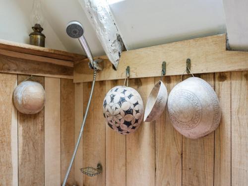 a wall with pots and utensils hanging on it at Sunny Watermill with Heated Pool in Brandonnet