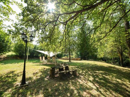 a park with a bench and a light pole at Sunny Watermill with Heated Pool in Brandonnet