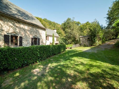 an old stone house with a green yard at Sunny Watermill with Heated Pool in Brandonnet