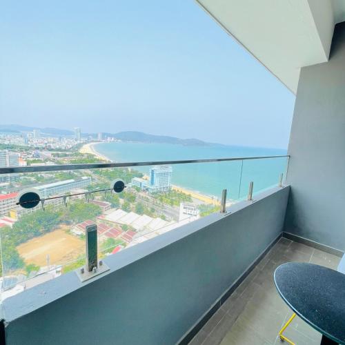a room with a balcony with a view of the ocean at FLC Sunny Beach Quy Nhon Apt in Quy Nhon