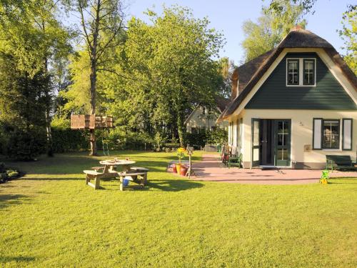 a house with a picnic table in the yard at Holiday Home in Heeten near Forest in Heeten