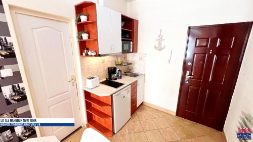 a small kitchen with a sink and a stove at Little New York West Side Apartments in Budapest