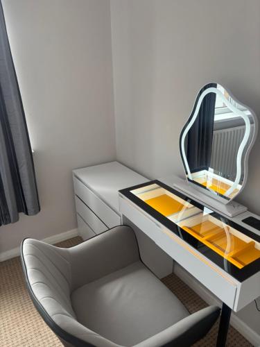 a desk with a mirror and a chair in a room at Blencathra in Penrith
