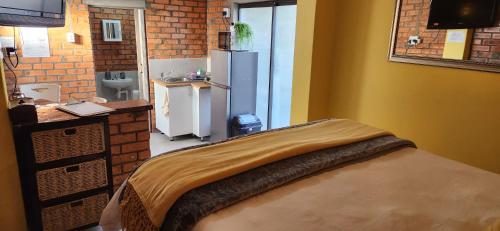 a small kitchen with a refrigerator and a sink at LyonsDen 1 in Worcester