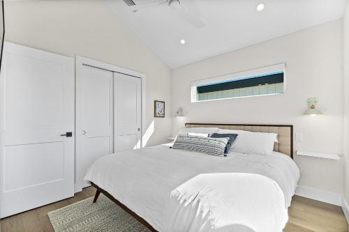 a white bedroom with a bed and a window at St. Francis Inn - Saint Augustine in Saint Augustine