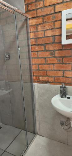 a bathroom with a glass shower and a sink at LyonsDen 1 in Worcester