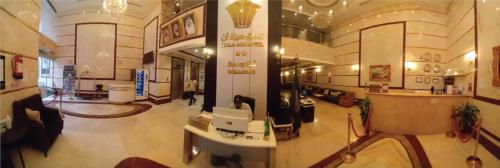 a lobby of a building with a woman sitting at a desk at فندق هيلا آن للايواء السياحي Hailaann Hotel in Quai