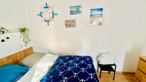 a bedroom with a bed and a clock on the wall at Apartament nr 3 przy Sali Kominkowej in Przeczyce