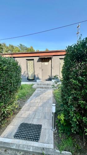 a building with a door and a path leading to it at Apartament nr 3 przy Sali Kominkowej in Przeczyce